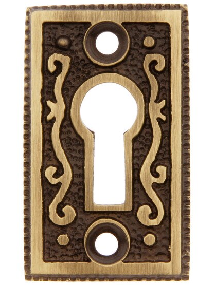 Solid Brass Ornate Keyhole Cover in Antique Brass.